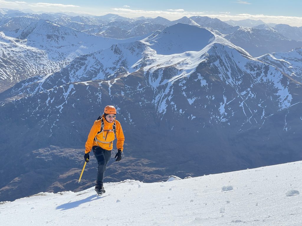 Solo hiker on snowy mountain slope