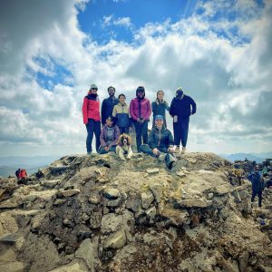 Group on summit with dog