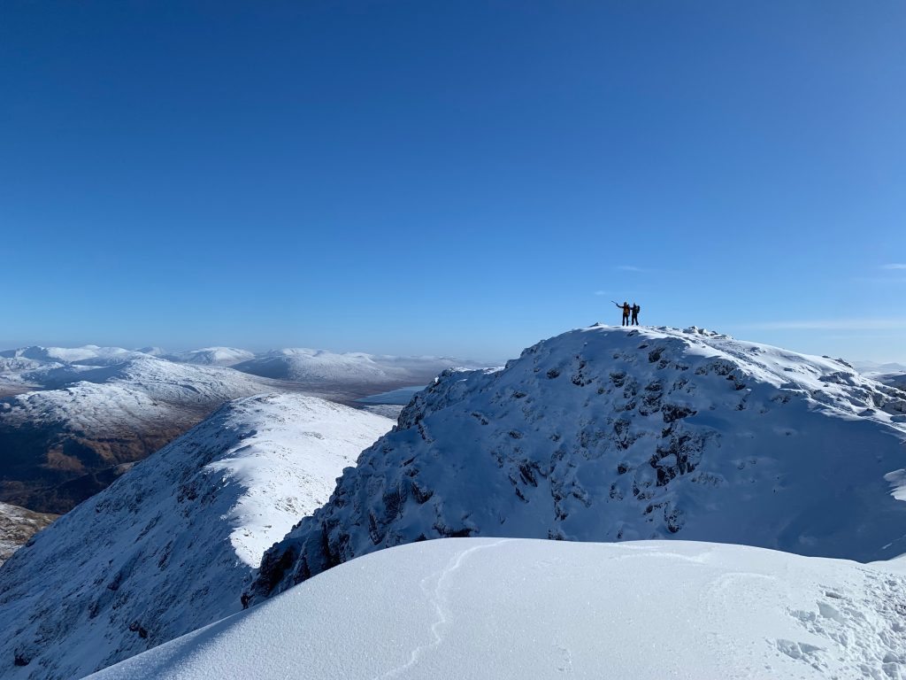 Hikers on snowy ridge
