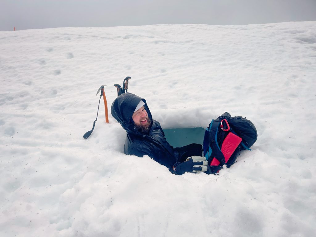 Hiker sat in a snow hole