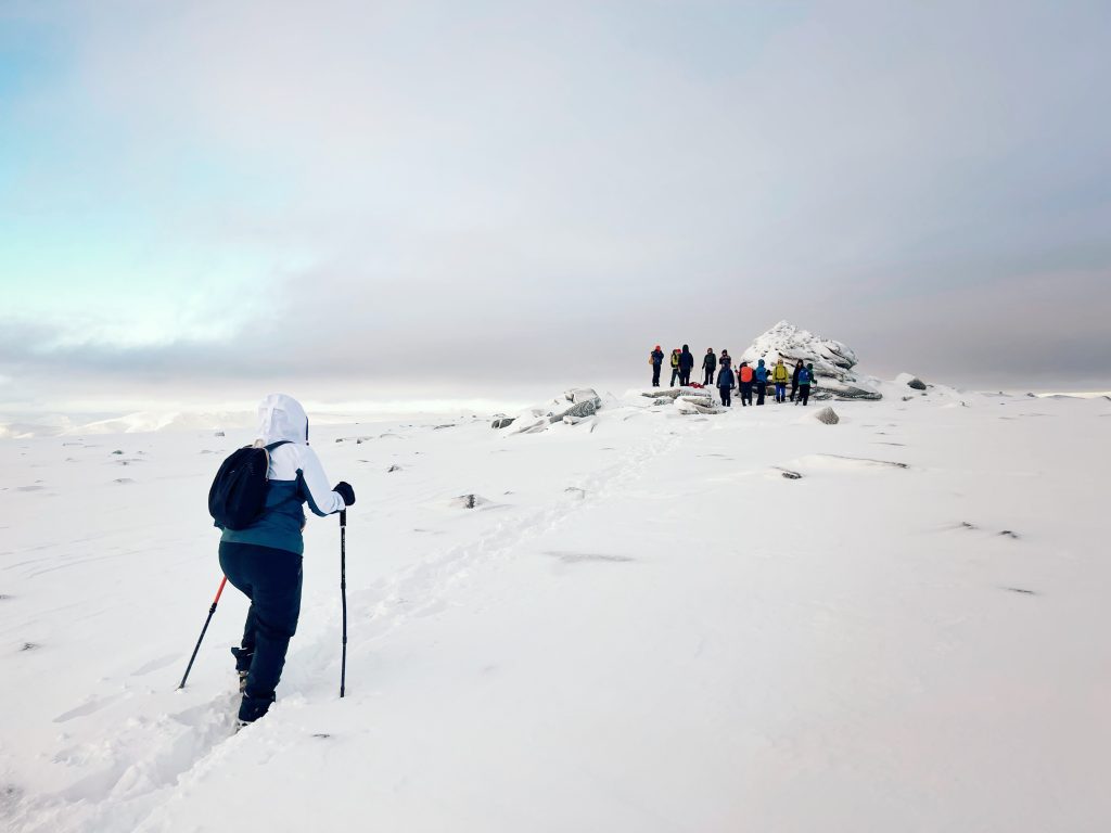 Hiking to a snowy mountain summit