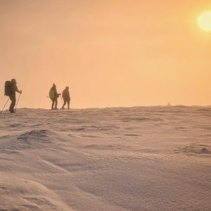 Winter hiking group at sunset
